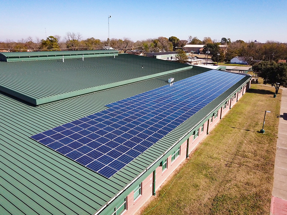 Commercial solar and battery installation at an auto dealership facility