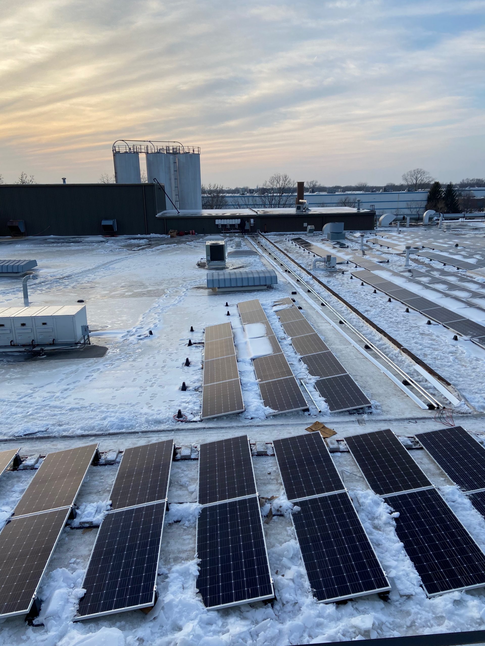 Commercial solar array installed on an Edmonton rooftop during winter